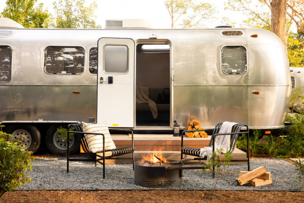 Airstream and outdoor sitting area at campsite at Autocamp Cape Cod