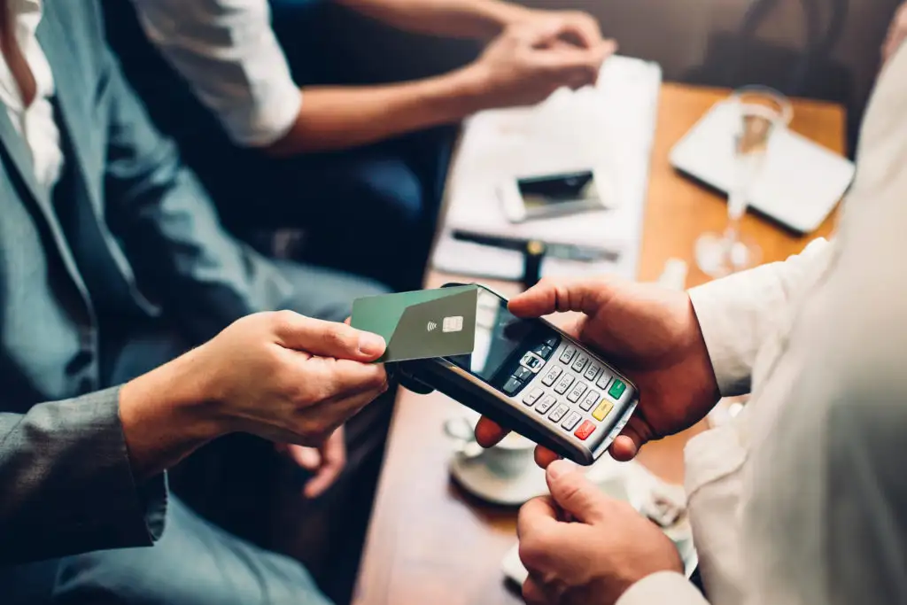 Close up of person paying with contactless credit card transaction