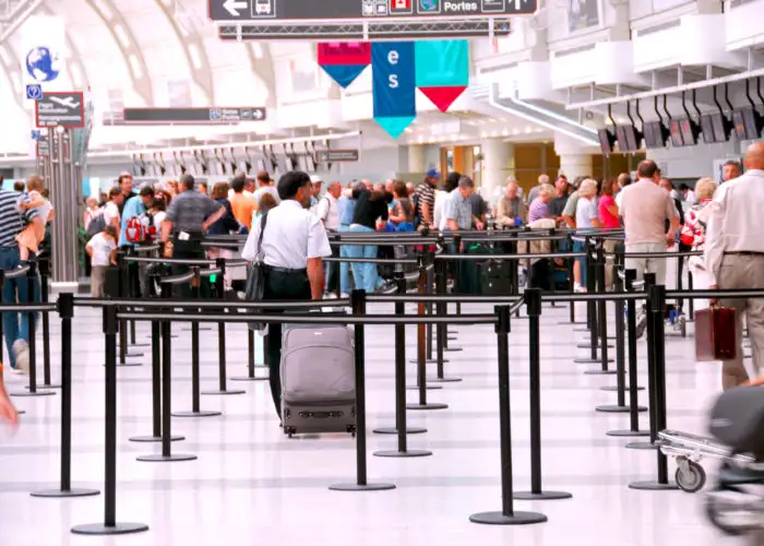 Crowd of people waiting in line at airport