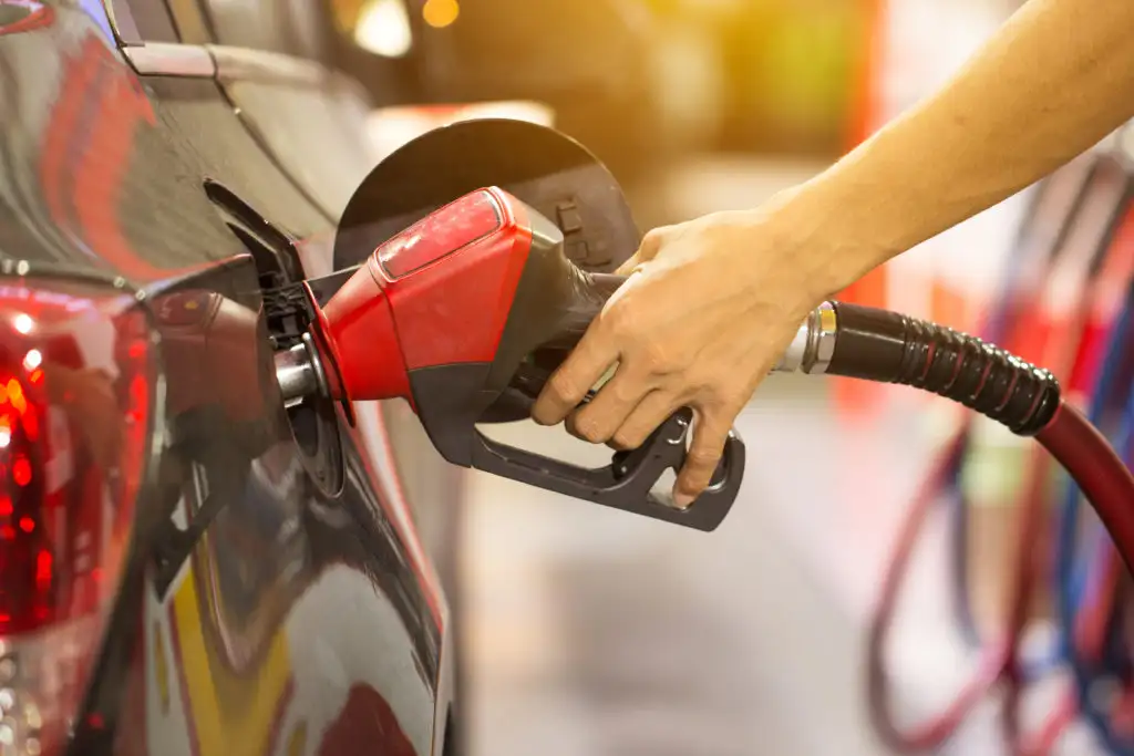 Close up of hands as person puts gas in their car