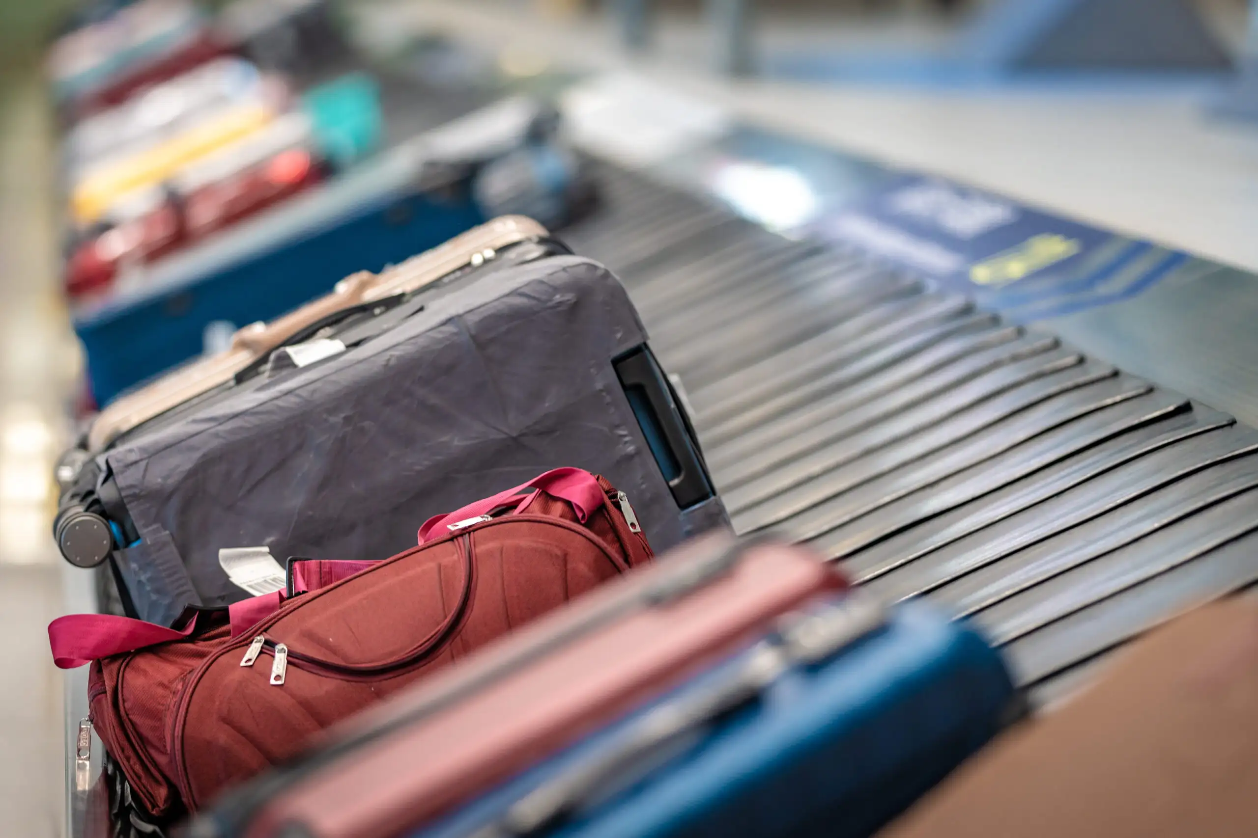 Checked luggage on a baggage carousel in an airport