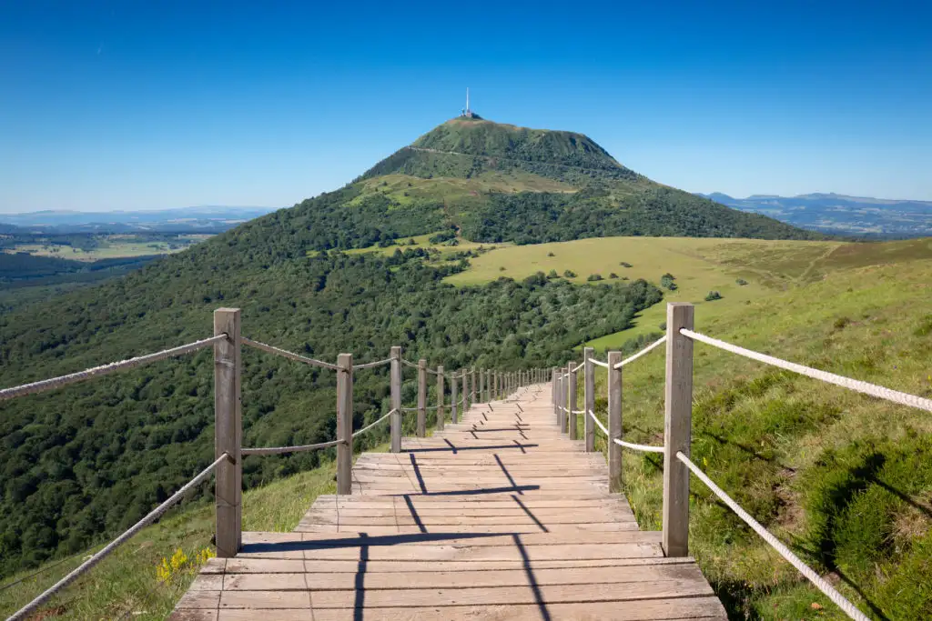 Wooden pathway leading toward Puy de Dôme, France
