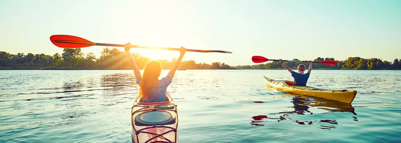 Two people kayaking at sunset