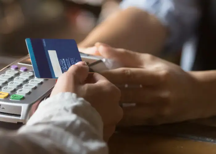 Close up of person paying for purchase using credit card