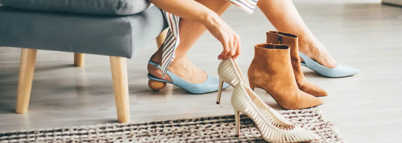 Woman trying on multiple pairs of heeled shoes