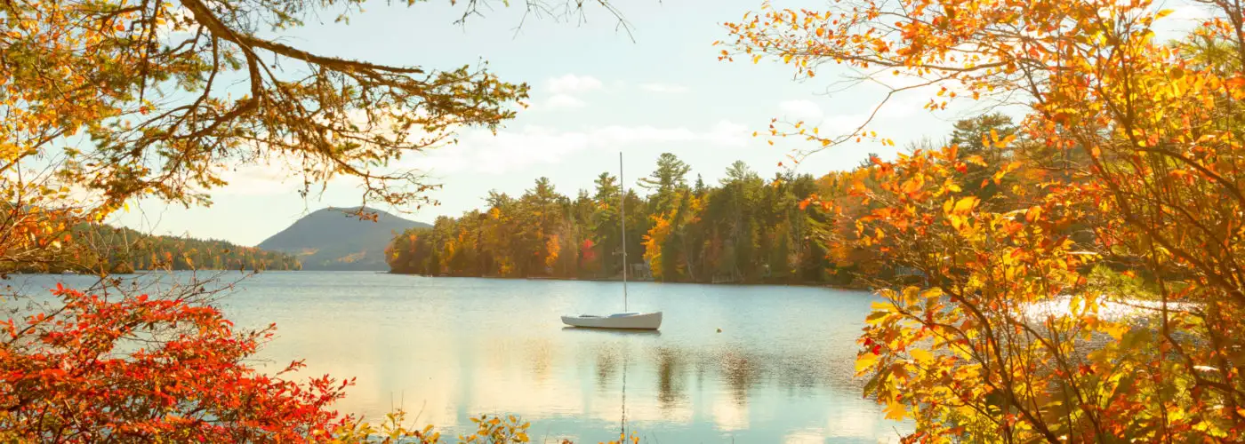 Long Pond seen through trees with autumn foliage in Acadia National Park in Maine, United States