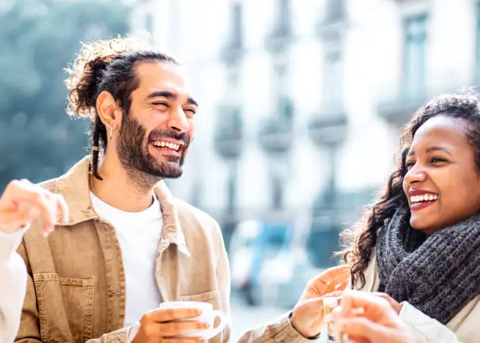 Four friends laughing at a coffeeshop