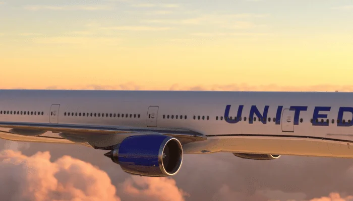 Boeing 777 United Airlines flying over amazing sunset