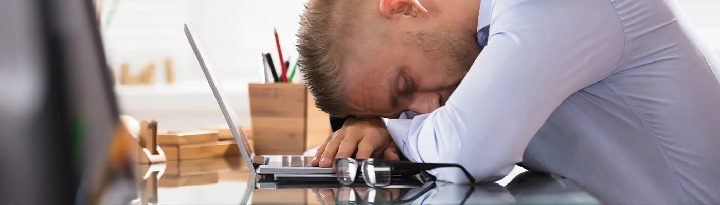 Businessman Sleeping Over The Desk