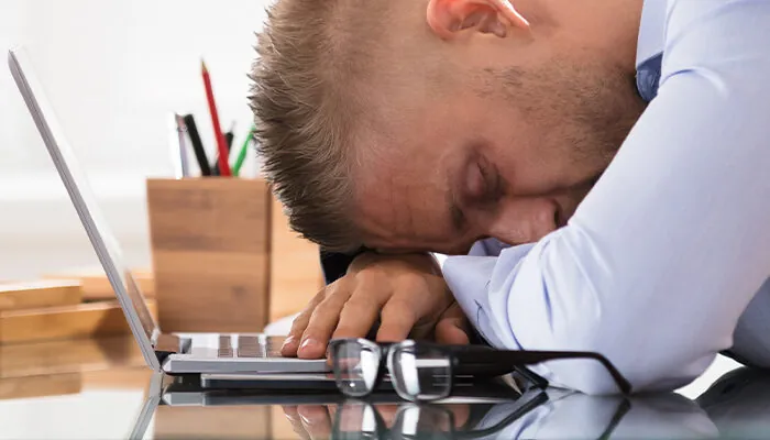 Businessman Sleeping Over The Desk