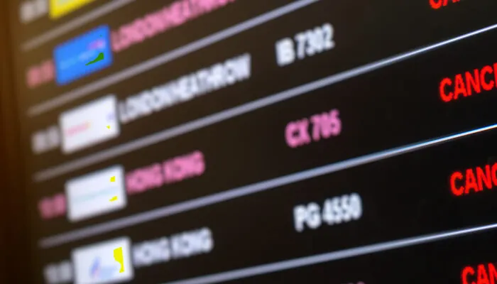 Arrivals board showing cancelled flights at airport