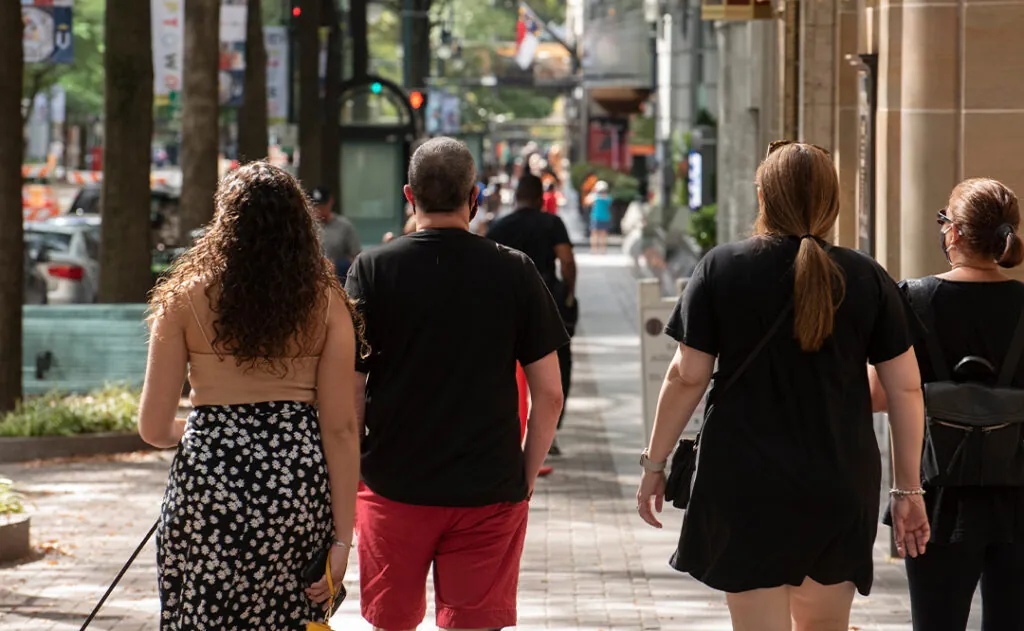 A family strolls through downtown together.