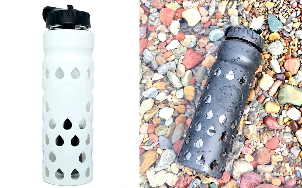 The Escape filtered water bottle in white (left) and The Escape filtered water bottle in black on a bed of pebbles (right)