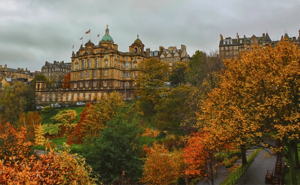 Gorgeous and colorful autumn or early winter's view of Edinburgh from Princes Street Garden with the sun popping out after a storm.