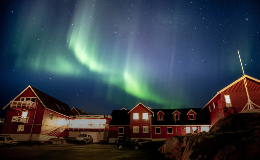 Northern aurora over the seaman's house , Greenland