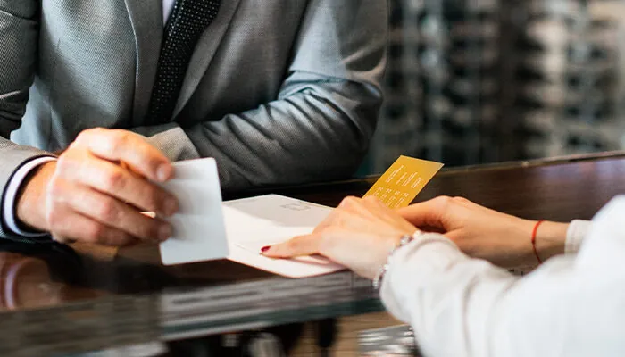 Person checking out at hotel front desk