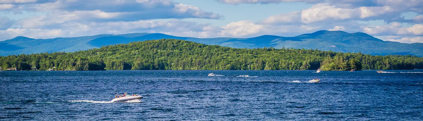 Boats on Lake Winni with the mountains in the background during the summer.