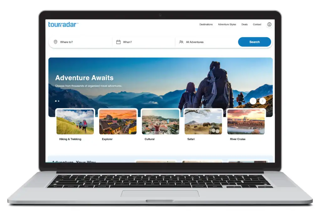 An open laptop showing the homepage of TourRadar, a site with the option to book late travel