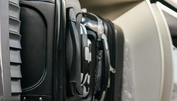 Luggage in overhead bin on airplane