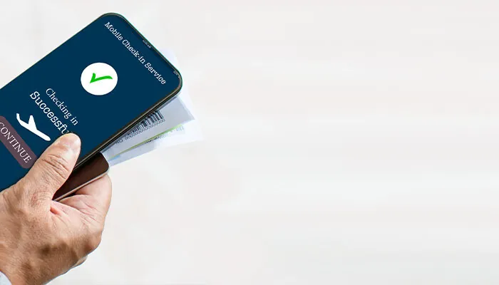 Tourists holding smartphones showing Concept Mobile check-in app check-in before their flight Business people use online devices to verify their identity. Close up, Copy space. Blurred background.