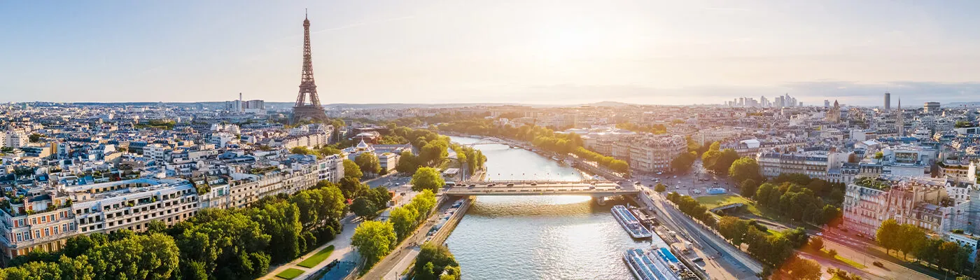 Paris aerial panorama with river Seine and Eiffel tower, France. Romantic summer holidays vacation destination. Panoramic view above historical Parisian buildings and landmarks with blue sky and sun