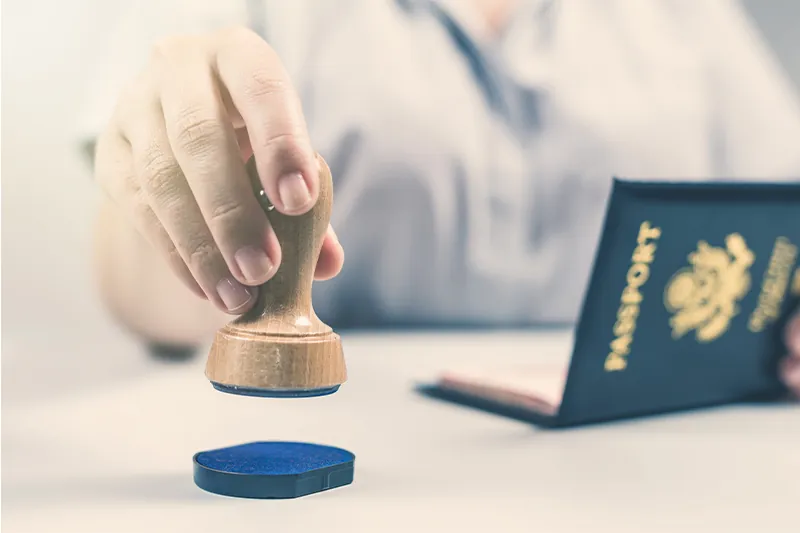 Close up of person stamping a United States passport