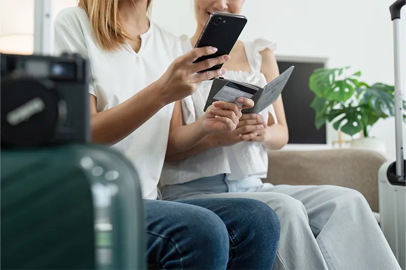 Couple booking flights on couch