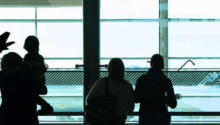 people looking out the window at the airport