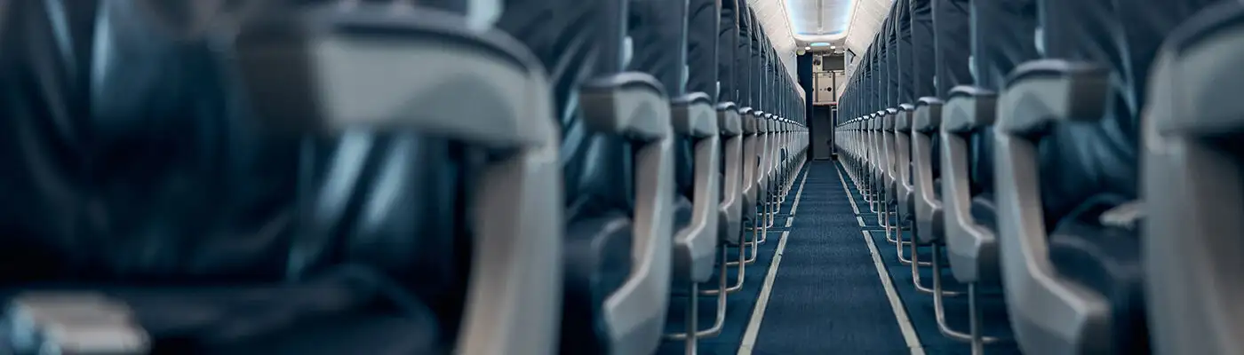 Looking down the central aisle of an empty airplane