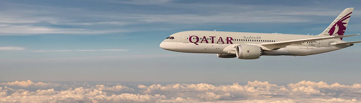 Qatar Airways in the air above the clouds