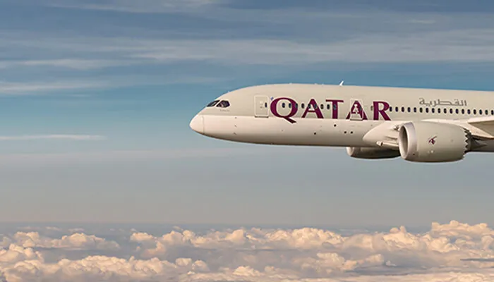 Qatar Airways in the air above the clouds