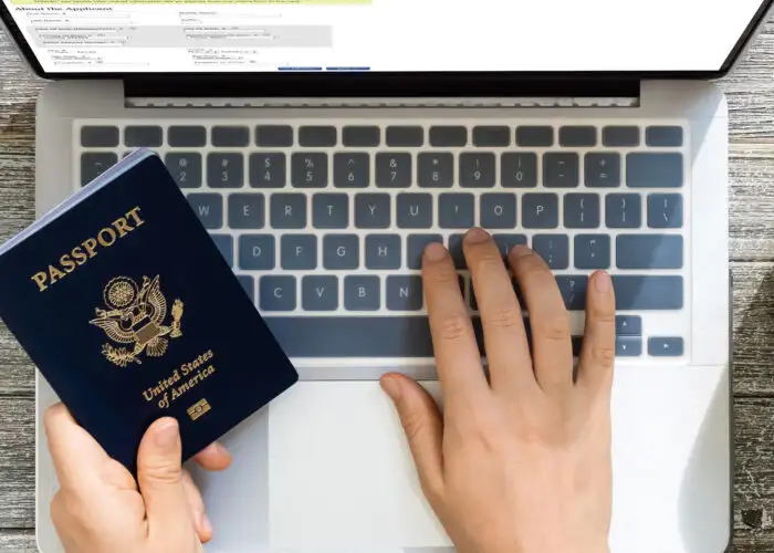 person using laptop to renew passport