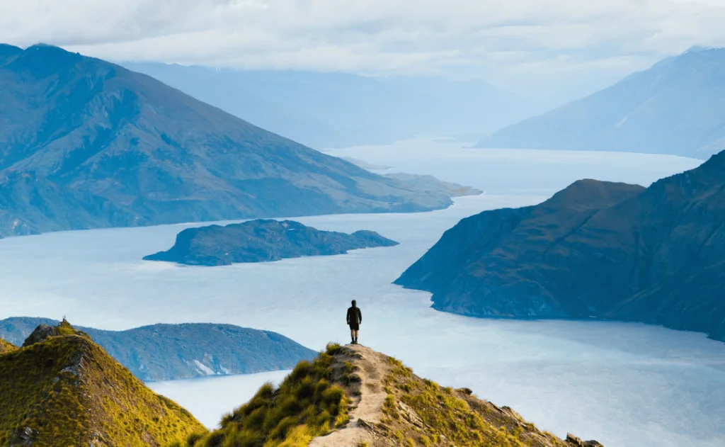 Roys peak mountain hike in Wanaka New Zealand. Popular tourism travel destination. Concept for hiking travel and adventure. New Zealand landscape background. See Less