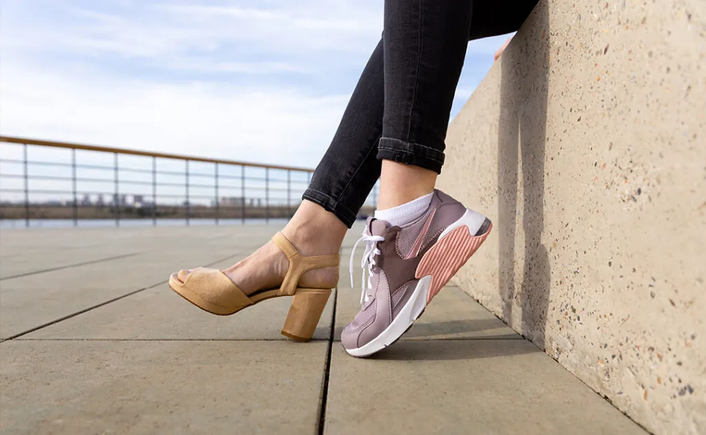 Woman in shoes and sneakers. Woman choosing comfortable sneakers