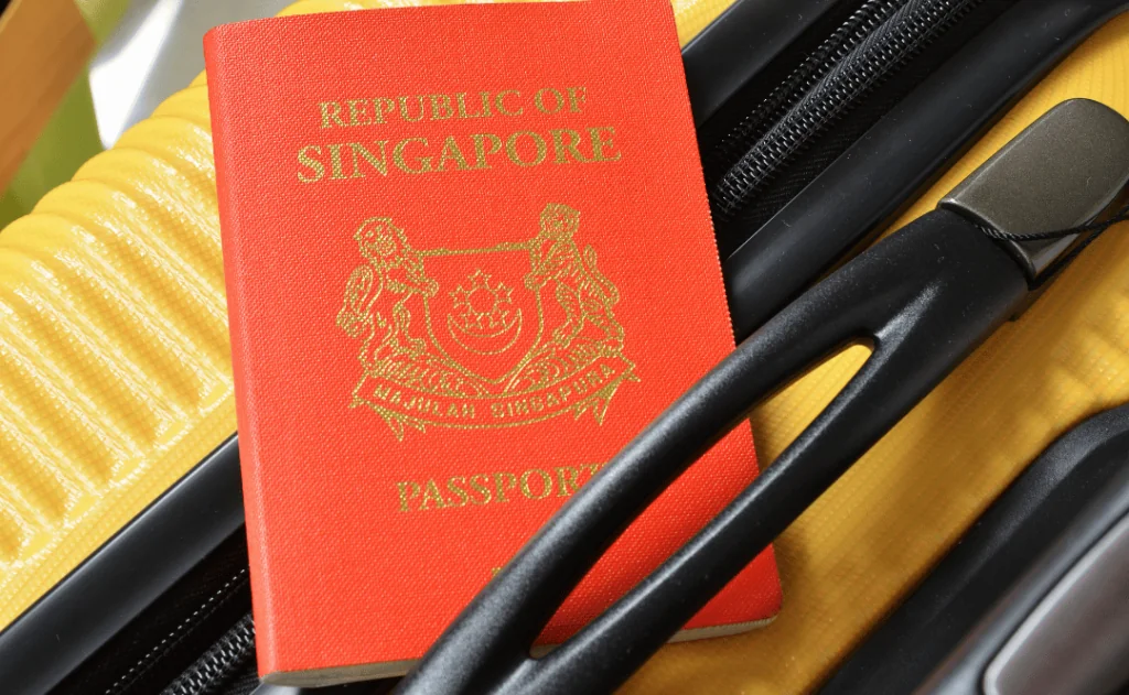 Singaporean passport on the yellow suitcase