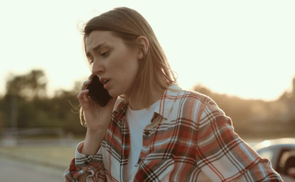 Stressed looking young woman talking on the phone