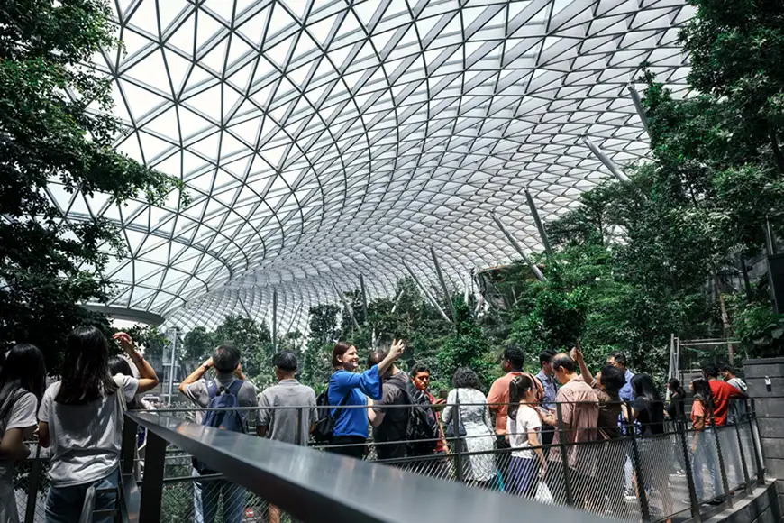 Tourist takes photo at The HSBC Rain Vortex