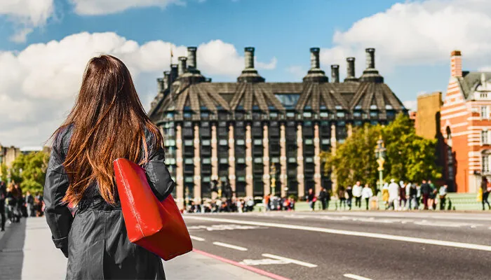 Woma walking in London near Big Ben