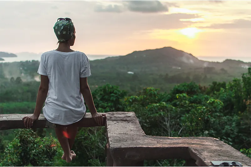 Woman watching sunset in Thailand